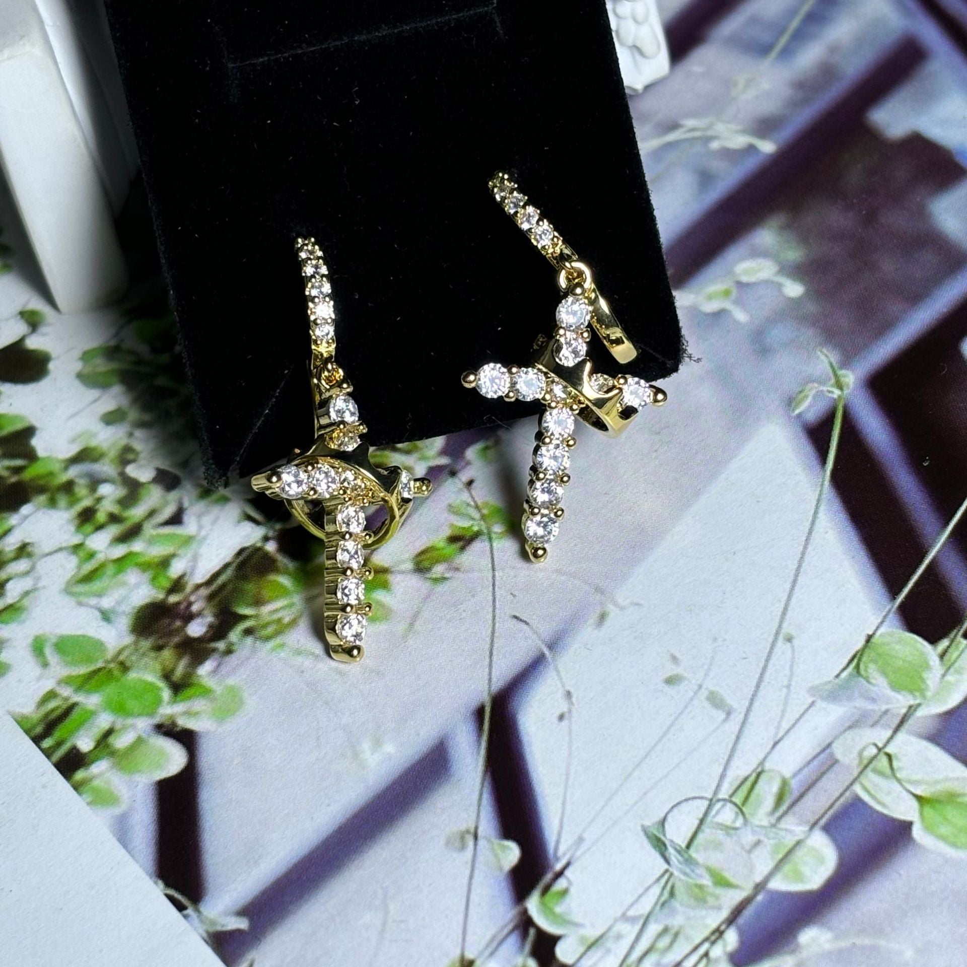 Luxury earrings with a crown and cross design, set with precious stones Luxury earrings with a crown and cross design, set with precious stones