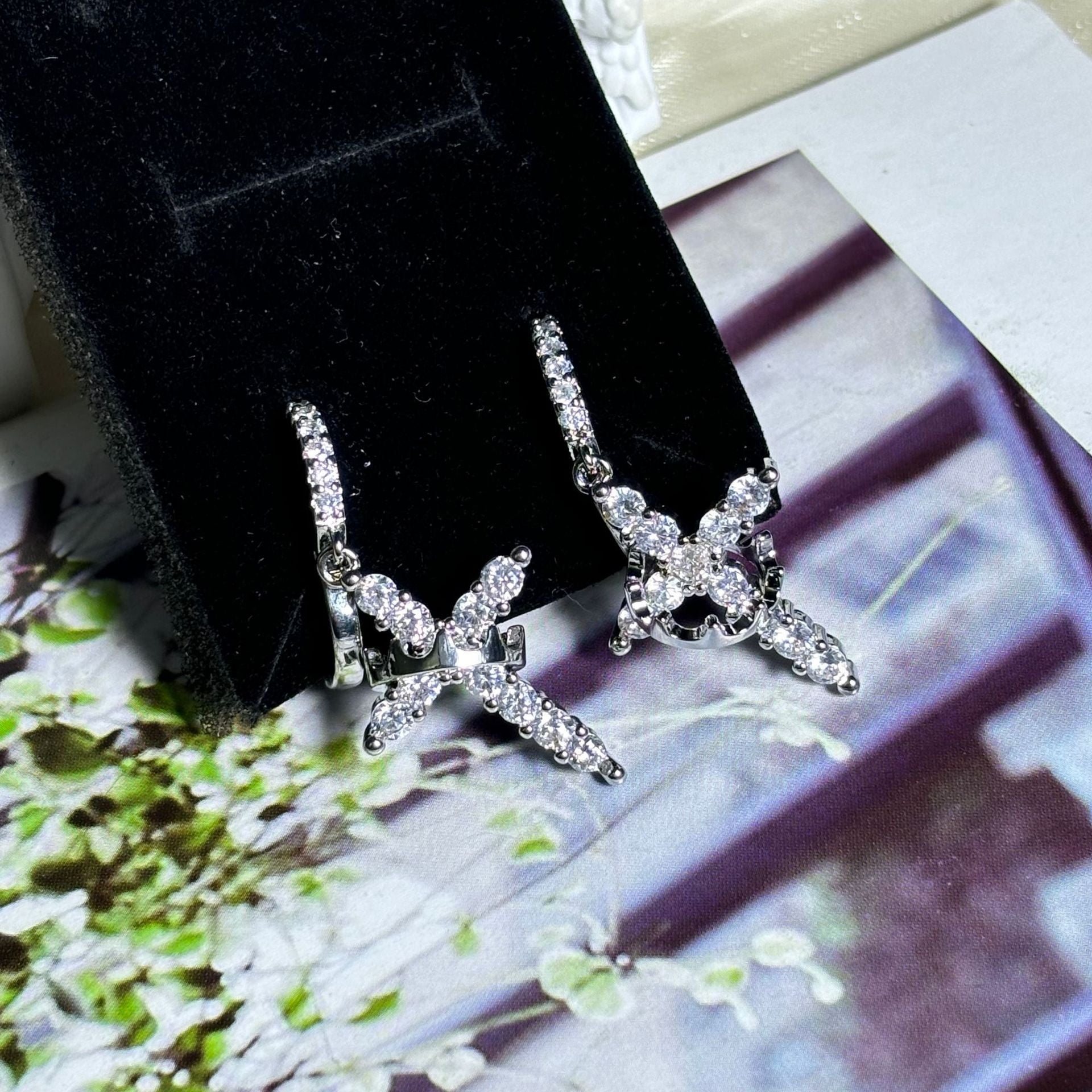 Luxury earrings with a crown and cross design, set with precious stones Luxury earrings with a crown and cross design, set with precious stones